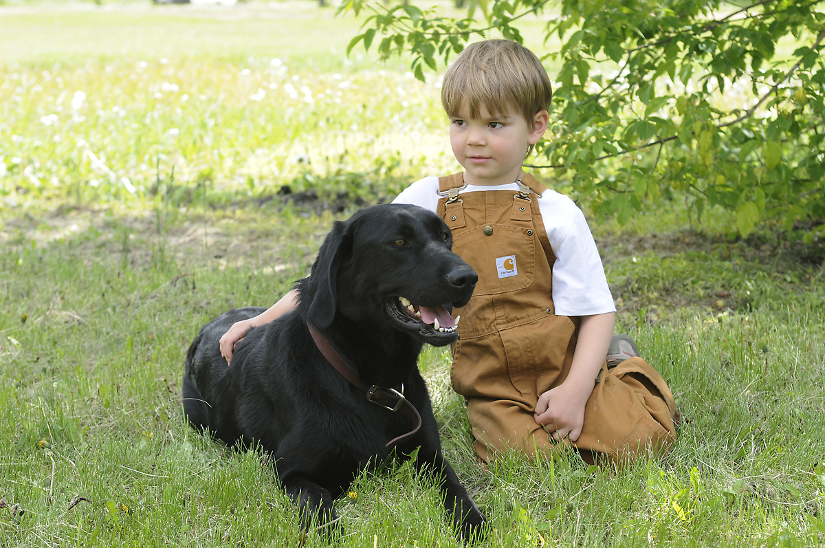 portrait of a young boy with his dog